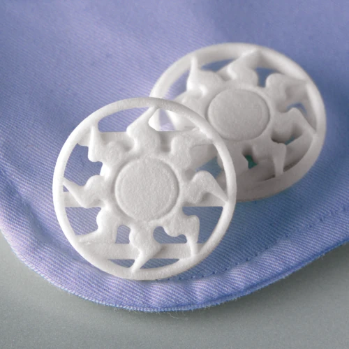 Product photography of 3D printed Cuff links (sun motif in white). Post production included:

- Colour and tone alterations
- Shifting the shirt colour to blue (from white)
- Minor image retouching

Client: WhatNick INC